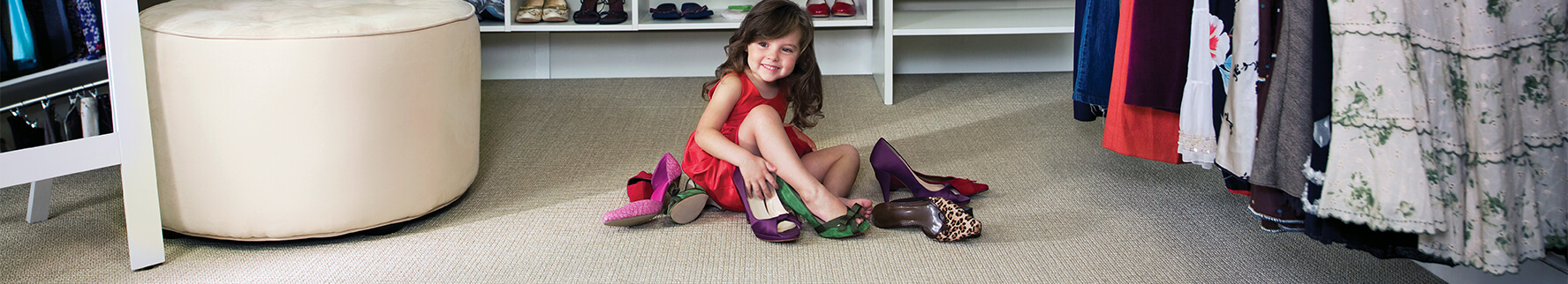 beige Bigelow carpet in a large master closet, girl playing with shoes 